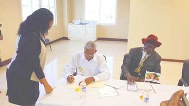 APNU+AFC Coalition presidential candidate David Granger (seated, left) was the first of the eight party leaders that signed the Code of Conduct during a press conference held at Gecom’s Command Centre yesterday.  