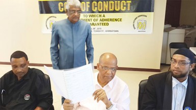 PPP General Secretary Clement Rohee (seated, centre) attended the signing although the document was already signed by President Donald Ramotar earlier yesterday at the Office of the President. 