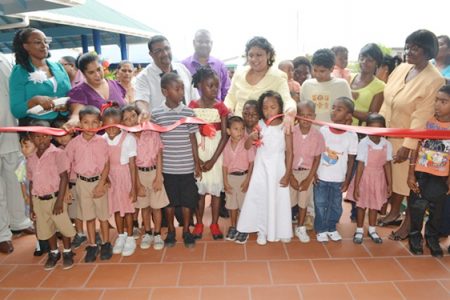 Students of the school along with Minister of Education, Priya Manickchand cut the ribbon to officially commission the school (GINA photo)