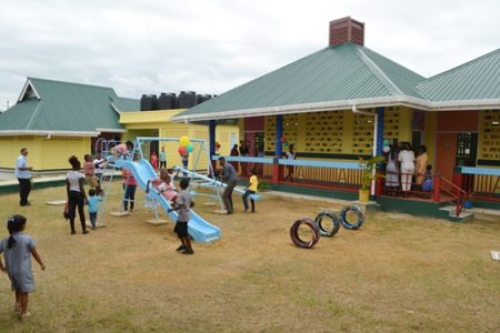 Children enjoying the play facilities in the Number 77 Village Nursery school compound (GINA photo)