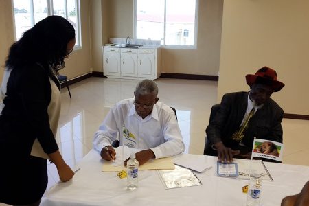 Leader of the Opposition David Granger (centre) was the first representative of the eight parties who signed the elections Code of Conduct during a press conference held at Gecom’s Command Centre today. 