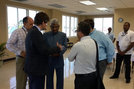 GECOM Chairman, Dr Steve Surujbally (centre) in discussion with diplomats and others at today’s signing of the code of conduct at Gecom’s Command Centre.