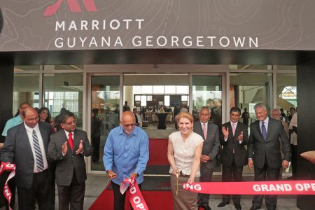 President Donald Ramotar (third from left) helping to cut the ribbon today to officially declare the Marriott Hotel open.