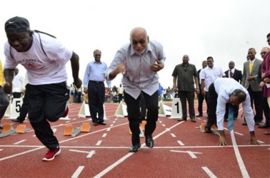 And they’re off! Bursting out of the starting blocks, President Donald Ramotar getting into his stride while Minister of Culture, Youth and Sport Dr. Frank Anthony is yet to leave his mark. (GINA photo)