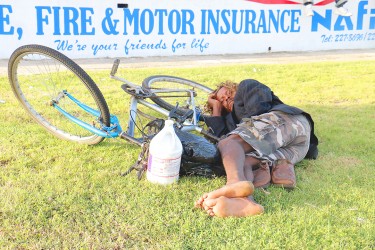 This man was resting up along the Kitty seawall on his bicycle with his shoes secured under him. (Arian Browne photo)