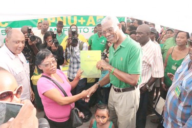 Presidential candidate David Granger handing over a copy of the manifesto 