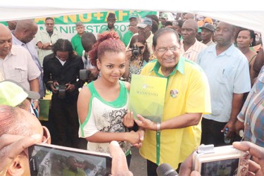 Prime Ministerial candidate Moses Nagamootoo handing over a copy of the manifesto 