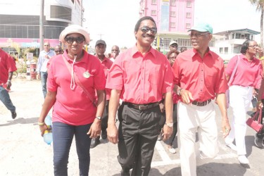 APNU+AFC presidential candidate David Granger (at far right) chats with coalition candidate Basil Williams as they walk with Guyana Trades Union Congress (GTUC) affiliates during yesterday’s Labour Day march. (Arian Browne photo) 