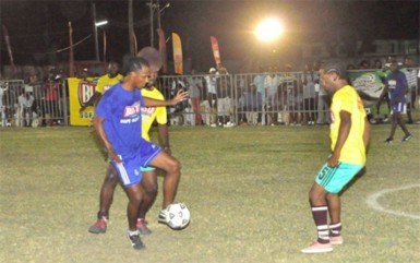 Gregory Richardson of Sparta Boss (centre) trying to maintain possession of the ball while being surrounded by two Kitty Weavers players in their semi-final showdown      
