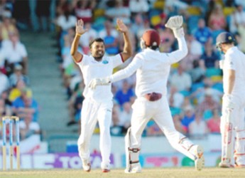 Veerasammy Permaul celebrates with Denesh Ramdin after he dismissed Moeen Ali on day two of the third and final Test West Indies v England at Kensington Oval, Bridgetown, Barbados  yesterday. Photo by WICB Media/Randy Brooks of Brooks Latouche Photography 