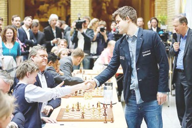Norwegian world chess champion Magnus Carlsen lent a helping hand to launch his country’s Chess in Schools programme recently. He conducted a simultaneous chess exhibition for students and their parents to give stimulus to the activity. In the photo Carlsen accepts a girl’s resignation.