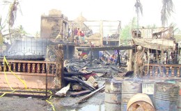 Residents searching through the rubble after fire fighters were successful in extinguishing the fire