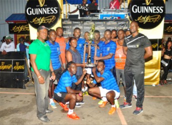 Captain of the victorious Amelia’s Ward Russian Travis Whatterton collecting the championship trophy from Banks DIH Representative Shondel Easton while Guinness Brand Manager Lee Baptiste (right) and other members of the team look on 