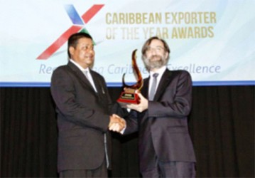 NPI General Manager Mahendra Persaud receiving the  award in Kingston, Jamaica. 