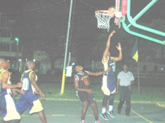 Nicholas Cassius (no.15) of Plaisance Guardians in the process of scoring two points from a layup during his side’s comprehensive win over University of Guyana Trojans in the GABA Hard-Court Championship. 