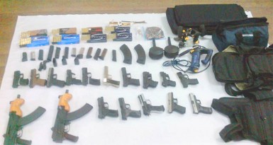 The weapons and other items that were discovered by customs officials yesterday. (Guyana Police Force photo)  