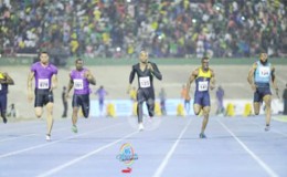 Asafa Powell centre sprinting to victory.