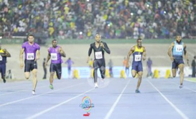 Asafa Powell centre sprinting to victory.