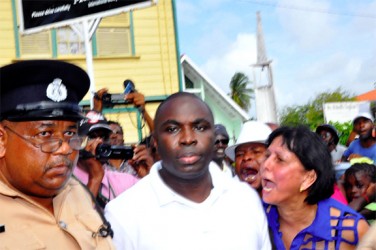 Kwame McCoy, escorted by police, leaving the St Sidwell’s polling station.