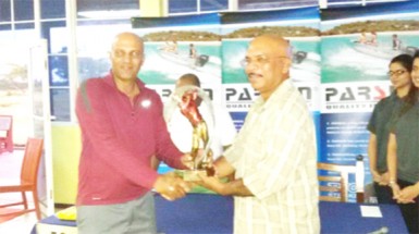 Patanjalee Persaud (left) receiving the champion’s trophy from sibling and Managing Director of Crown Mining Supplies Mahendra Persaud following the conclusion of the tourney