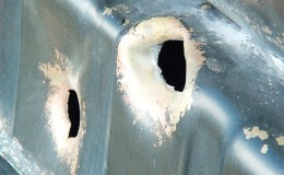 Bullet holes in the radiator of one of the damaged vehicles at the camp
