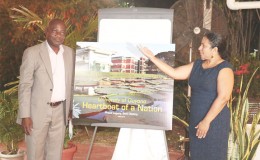 UG Vice-Chancellor Jacob Opadeyi (at right) and Dr. Paloma Mohamed unveiling the cover of the new book. 