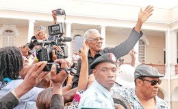 President David Granger waves to the crowd after his swearing-in at Public Buildings 