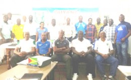  The participating members (standing) alongside course instructors (sitting) of the GFF Referee Instructor/Assessor Clinic posing for a photo opportunity following its conclusion.
