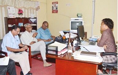 President David Granger (centre at left),  Minister of State, Joseph Harmon (third from left), and Permanent Secretary of the Public Service Ministry, Hydar Ally (left) during a meeting at the Public Service Ministry’s Training Division with Soyinka Grogan, Manager of the Scholarship Division. (GINA photo) 