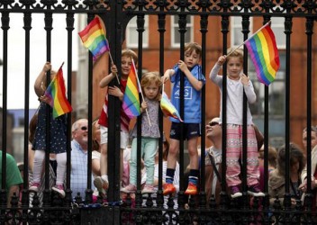 Children wave rainbow flags as they stand with their same-sex marriage supporting parents at Dublin Castle in Dublin, Ireland May 23, 2015. (Reuters/Cathal McNaughton)