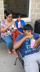 Wife of the PM Sita Nagamootoo  having ice cream with two of her grandsons 
