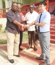 In this photo, CHEC’s Kevin Wang (right) hands over a cheque to Coordinator of the clean-up activities, Larry London. Observing are; (L) Clinton Williams, Chairman of the Guyana-China Business Council and Bobby Vieira, Assistant Coordinator of the clean-up activities.