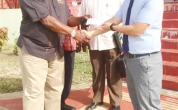In this photo, CHEC’s Kevin Wang (right) hands over a cheque to Coordinator of the clean-up activities, Larry London. Observing are; (L) Clinton Williams, Chairman of the Guyana-China Business Council and Bobby Vieira, Assistant Coordinator of the clean-up activities.