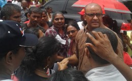 Former president Bharrat Jagdeo is flocked by supporters outside the Whim Magistrate’s Court yesterday.
