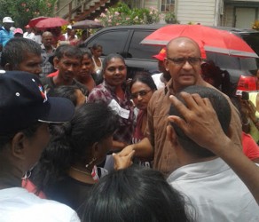 Former president Bharrat Jagdeo is flocked by supporters outside the Whim Magistrate’s Court yesterday.  