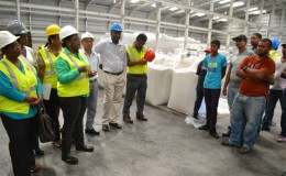 Minister in the Ministry of Social Protection Simona Broomes  addressing a group of workers at the Enmore Packaging Plant (GINA photo)
 
