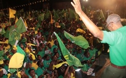 Presidential candidate David Granger waving to the crowd last night at the APNU+AFC  rally at the Square of the Revolution.