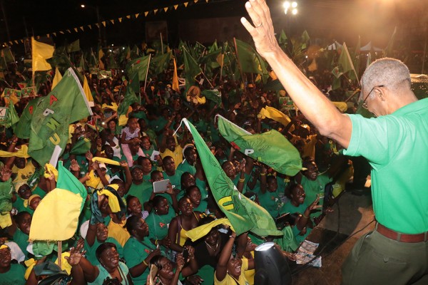 Presidential candidate David Granger waving to the crowd last night at the APNU+AFC  rally at the Square of the Revolution.