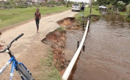 An eroded street in Ann’s Grove, East Coast Demerara. Residents said a rice combine had passed along the road a few months ago and caused it to break away. (Photo by Arian Browne)