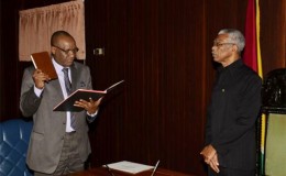 President David A. Granger, Commander of the Armed Forces, as he swore-in Retired Army Colonel Joseph Harmon as the Minister of State of the Ministry of the Presidency (GINA photo)