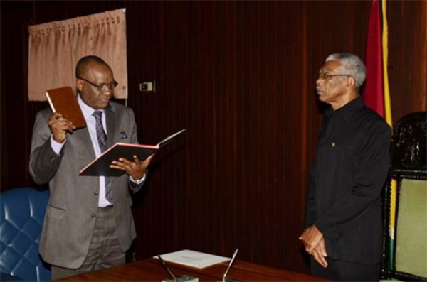 President David A. Granger, Commander of the Armed Forces, as he swore-in Retired Army Colonel Joseph Harmon as the Minister of State of the Ministry of the Presidency (GINA photo)