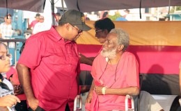 Housing Minister Irfaan Ali (left) chatting with Dr Roger Luncheon at the PPP/C rally at Lusignan yesterday.