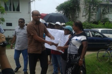 Former President Bharrat Jagdeo greeting supporters at the last court appearance.