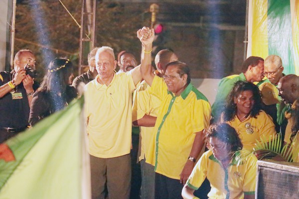 APNU+AFC  prime ministerial candidate Moses Nagamootoo (right) clenching hands with Dr Cheddi Jagan Jr at the rally last night at the Square of the Revolution.