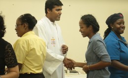 Here, Father Jerry Dias SJ, centre, greets one of the attendees.