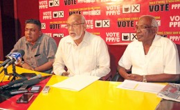 President Donald Ramotar (centre) speaking at Freedom House.  At left is PPP Secretary Zulfikar Mustapha. At right is party official Ganga Persaud.