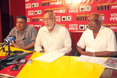 President Donald Ramotar (centre) speaking at Freedom House.  At left is PPP Secretary Zulfikar Mustapha. At right is party official Ganga Persaud.