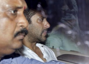 Bollywood actor Salman Khan (R) sits in a car as he leaves a court in Mumbai, India, May 6, 2015.  Reuters/Shailesh Andrade 