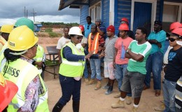 Minister in the Ministry of Social Protection Simona Broomes (centre) addressing workers at the East Montgomery mine (GINA photo)