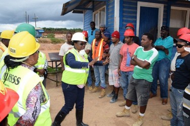 Minister in the Ministry of Social Protection Simona Broomes (centre) addressing workers at the East Montgomery mine (GINA photo)